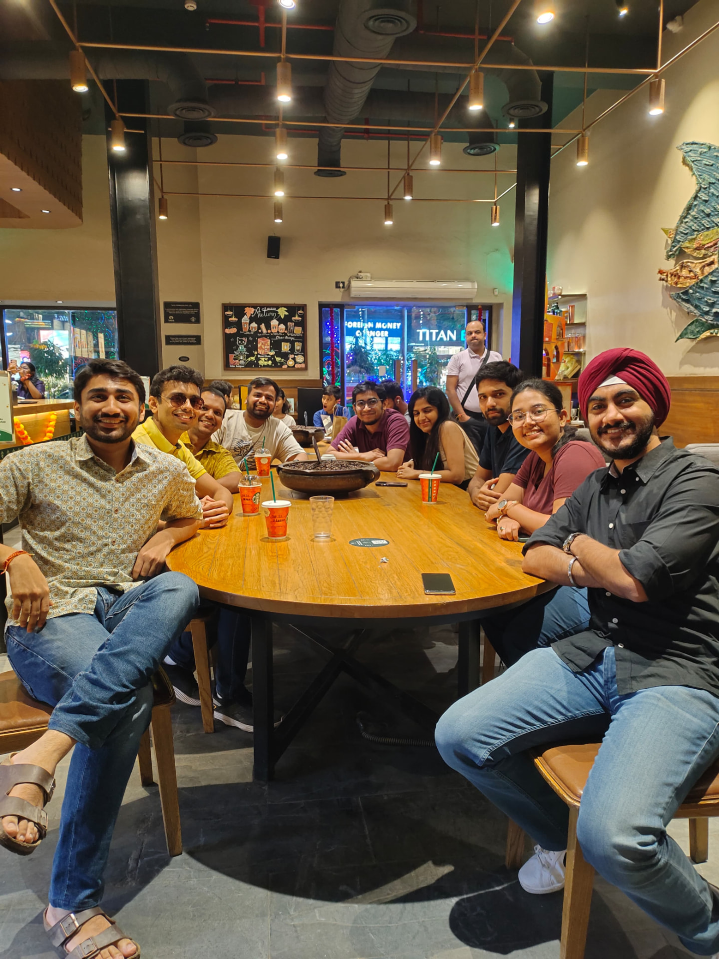 Members in conversation around a long table at a coffee catch-up