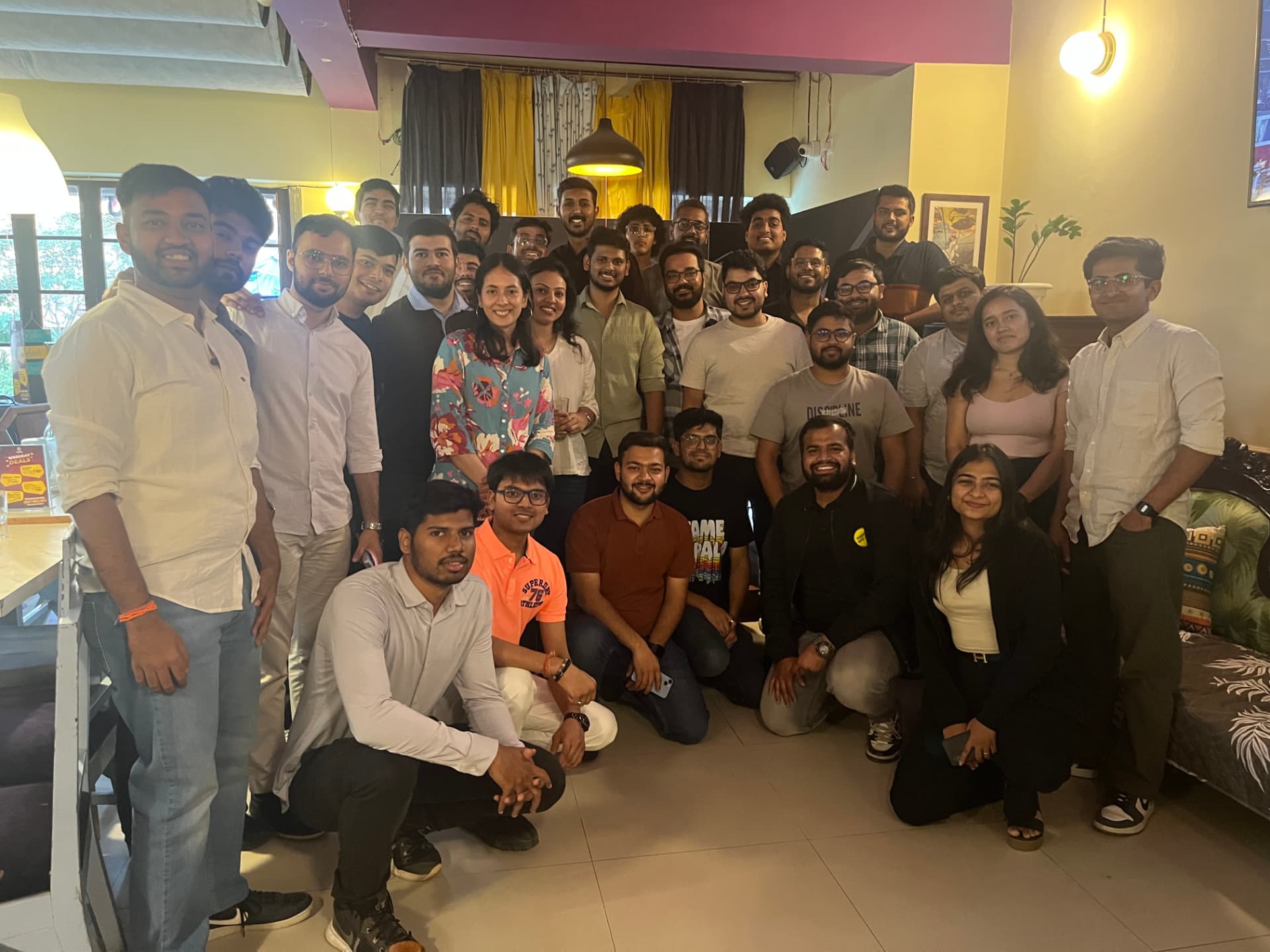 Members crowded together for a group photo at an FOC meetup in a cafe